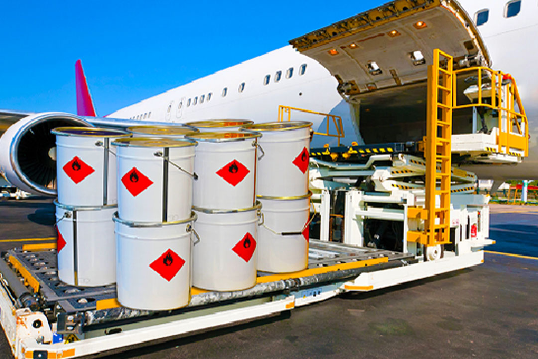 Dangerous goods drums labelled flammable being loaded onto an aircraft